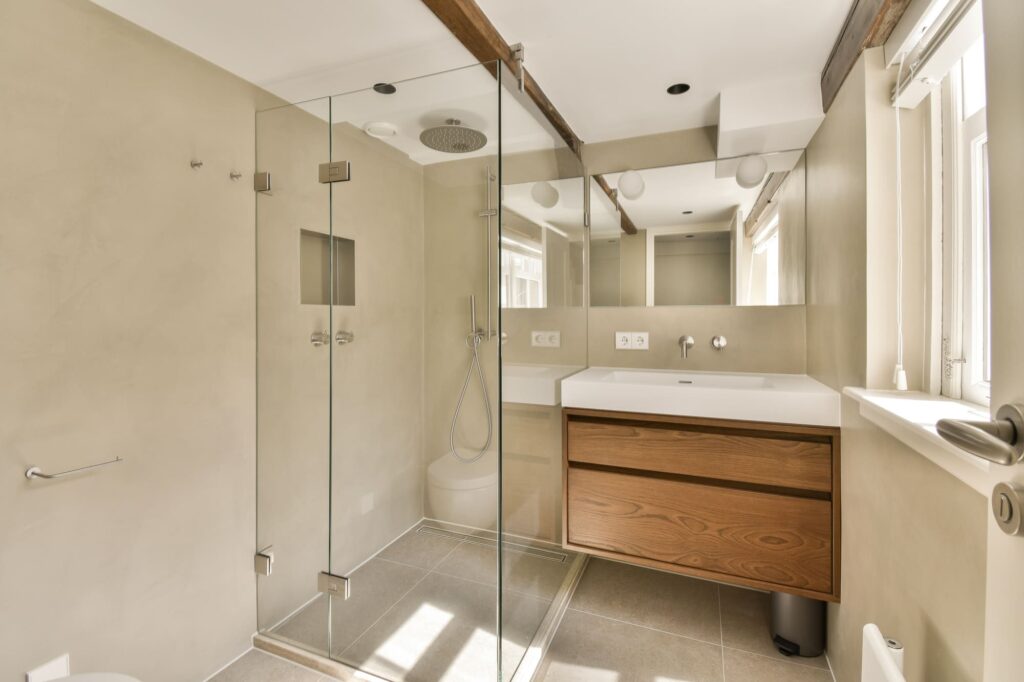 a-bathroom-with-a-glass-shower-and-a-sink-2023-11-27-05-17-01-utc